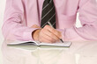 © Designpics - Close-up of Businessman Writing in Appointment Book