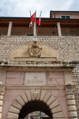 Wall Mural - Entrance of old town Kotor with post-World War II sign