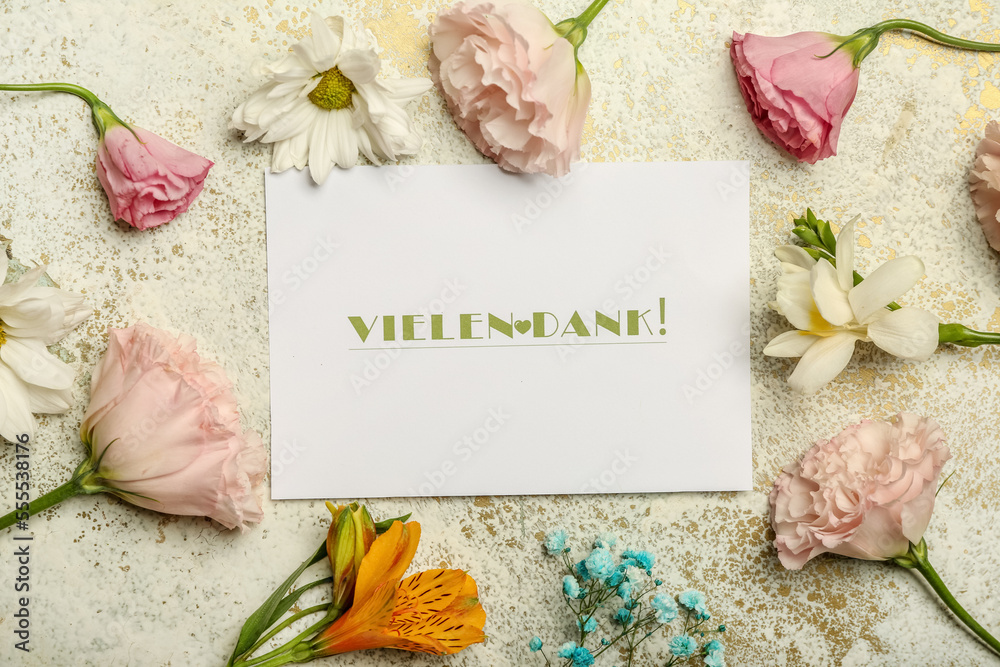 Card with text VIELEN DANK and different flowers on light background