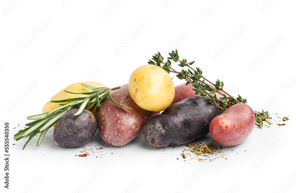 Heap of different raw potatoes and fresh herbs on white background