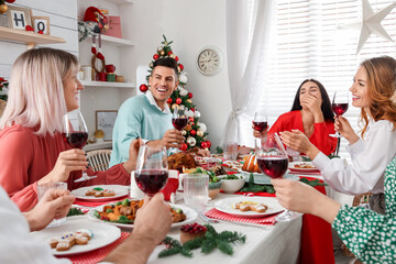 Sticker - Happy family with their friends enjoying festive dinner at home. Christmas Eve celebration