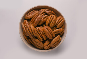 Wall Mural - Tasty fresh ripe pecan nuts on white background, top view