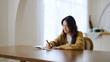 Beautiful young asian woman sitting and taking note at house. Happy smiling working online, Freelance work at home
