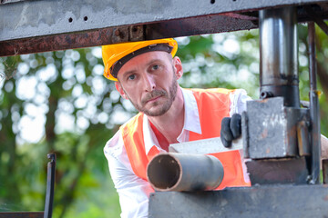 Close up of Construction engineer or worker checking quality steel for concrete foundation and check the quality of round bar at construction site or factory