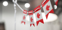 A Garland Of Canada National Flags On An Abstract Blurred Background