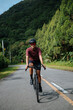 © Jonathan De Guzman - A young female cyclist riding her gravel bike in the mountains.