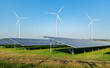 © APchanel - Solar panels and wind turbines open filed alternative EcoPower electricity  solar energy and wind energy hybrid power plant systems station use renewable energy to generate power concept.