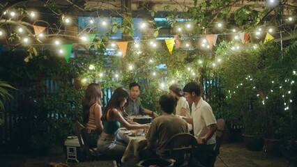 Wall Mural - Asian people having a barbecue party and drinking beer.