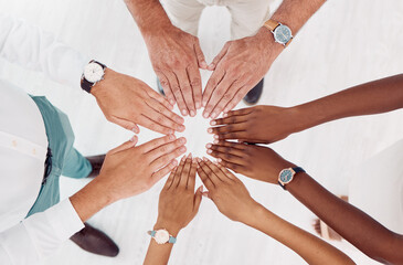 Teamwork, support and hands of business people in circle for motivation, community and trust in office. Collaboration, diversity and top view of employees hands together for vision, growth and goals