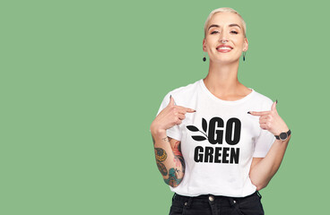 mockup, sustainable fashion and green background, woman with tshirt and space for eco friendly produ