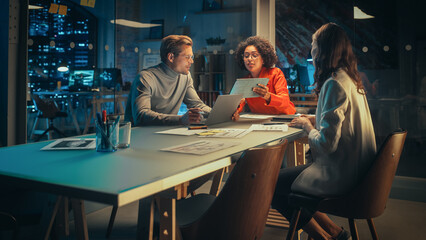 Wall Mural - Group of Young Successful Businesspeople Making a Team Meeting in Conference Room in Creative Agency. Excited Diverse Team Discussing a New Digital Marketing Plan.