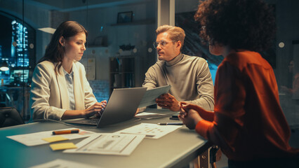 Aufkleber - Successful Young Small Business Owners Communicating at a Meeting in Office at Night. Beautiful Female and Handsome Male Discussing Corporate Agenda and Opportunities. Managers High Five Each Other.