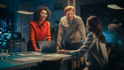 Wall Mural - Excited Marketing Manager Leading a Team Meeting in Creative Office Conference Room in the Evening. Confident Multiethnic Female DIscussing a New Project Plan with Agency Employees.