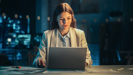 Poster - Talented Digital Marketing Specialist Working on Laptop in the Office in the Evening. Young Businesswoman Using Computer in Creative Agency, Checking Emails, Researching Business Analytical Data.