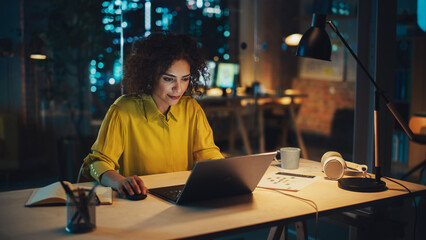 Aufkleber - Portrait of a Focused Multiethnic Manager Working in Creative Office. Business-Driven Stylish Female with Curly Hair Using Laptop Computer for Making Online Work and Writing Financial Reports.