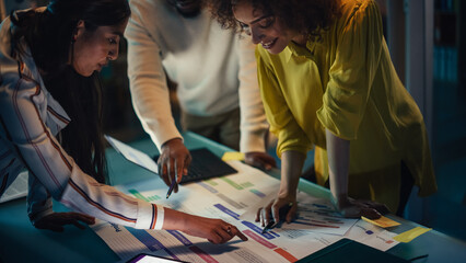 Poster - Diverse Creative Colleagues Discussing a New Business Opportunity, Talking in an Office Meeting Room in the Evening. Using Laptop Computer with Project Planning and Development Timeline.