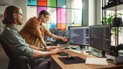 Poster - Male Programmer Shows Progress to Female Start-Up CEO on Desktop Computer in Creative Office Space. Caucasian Man and Woman Discussing New Features For Artificial Inteligence Software.