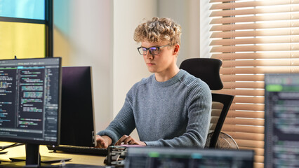 Poster - Male Software Engineer Coding On Desktop Computer in Creative Office Space. Young Caucasian Man Applying His Programming Skills in Innovative Technological Startup. Junior Developer Working.