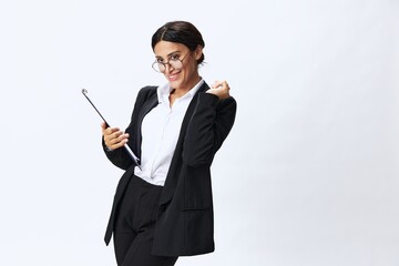 Business woman with a folder of documents in her hands in a black business suit and glasses shows signals gestures and emotions on a white background, work freelancer online training