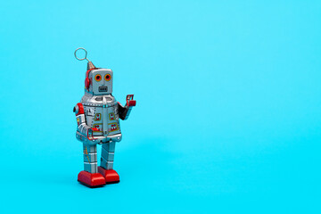 Retro robot toy on blue background