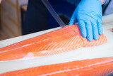 Fototapeta Fototapety z mostem - Japanese chefs filleting salmon, a delicate professional skill to make the most of the fillets.