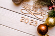 Happy new year 2023 on wooden white background

