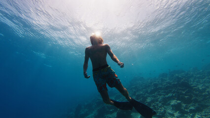 Man swims in the sea with mask