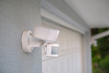 Motion Sensor With Light Detector Mounted On Exterior Wall Of Private House As Part Of Security System