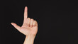 Looser hand sign on black background.