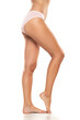 © vladimirfloyd - Side profile view of beautiful women legs and panties on a white background