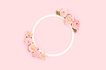 Wall Mural - Round frame made of rose flowers on a pink background. Cute festive floral concept.