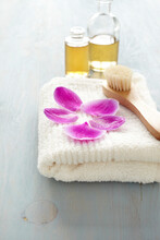 Orchid Petals On A Towel, Brush, Bottles Of Oil, Wellness