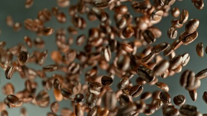 Poster - Super slow motion of rotating coffee beans on black background. Filmed on high speed cinema camera, 1000 fps placed on high speed cine bot.  Camera moving up with rotation. Speed ramp effect.
