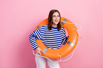 Canvas Print - Photo of charming positive lady hold inflatable safety ring look interested empty space isolated on pink color background