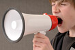 © Designpics - Boy Yelling through Megaphone
