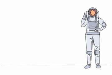 Poster - single continuous line drawing female astronaut stands with thumbs-up gesture wearing space suit exp