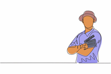 Poster - Single one line drawing young male film director cross arm on chest and hold clapping board. Professional profession occupation minimal concept. Continuous line draw design graphic vector illustration