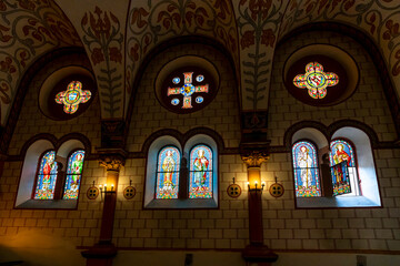 Wall Mural - Colorful stained glass windows inside the Chapelle Saint-Leon IX, a small chapel dedicated to Pope Leo IX in the medieval village of Eguisheim, France, along the wine route of the Alsace region.