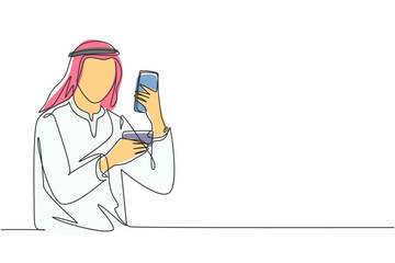 Poster - Single one line drawing young Arab man typing entering credit card code on smartphone around desk. Digital lifestyle and payment concept. Modern continuous line draw design graphic vector illustration