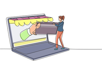 Poster - Single one line drawing young woman inserting credit card into large canopy laptop screen and accepted by hand. Digital payment concept. Modern continuous line draw design graphic vector illustration
