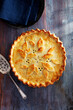 © Designpics - Tourtiere with a decorated crust on a blue wooden background