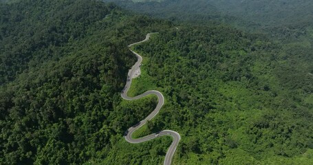 Wall Mural - aerial view ROAD No.1081 beautiful curve winding mountain road between Pua District,Nan Province, Northern of Thailand is check-in point and landmark that tourist shooting photo,4k video aerial view,