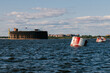 View from a boat on Fort Alexander the First in Kronstadt in the waters of the Gulf of Finland. Raid barrels for parking ships. Island of forts