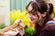 © Austockphoto - Lizard owner feeding pet bearded dragon lizard in garden
