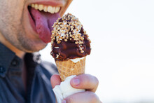 Man About To Eat Soft Serve Ice Cream With Choc Nut Toping On Sunny Day