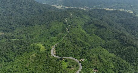 Wall Mural - aerial view ROAD No.1081 beautiful curve winding mountain road between Pua District,Nan Province, Northern of Thailand is check-in point and landmark that tourist shooting photo,4k video aerial view,