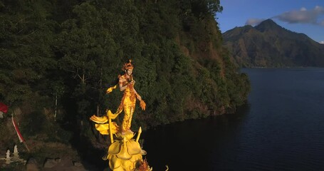 Wall Mural - Golden statue Pura Ulun Danu Bangli at Batur Lake,near east caldera Batur volcano,Bali island,Indonesia