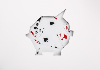 Wall Mural - Piggy bank from cut paper with playing cards. Gambling concept