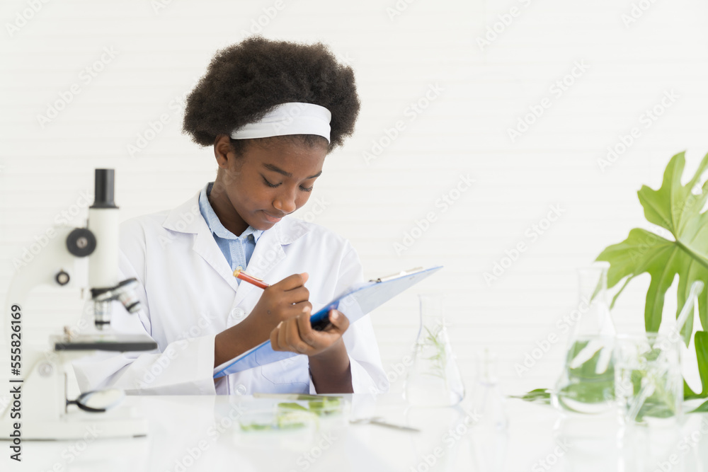 Germs Writing Young woman scientists learning and writing science and doing analysis ...