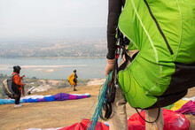 Paraglider On The Ground. Paragliders With Full Flight Equipment Look On Soaring Another Paragliders At "Wat Pha Tak Suea" Temple In Nong Khai Thailand , Landscape From Beautiful View Mekong River.